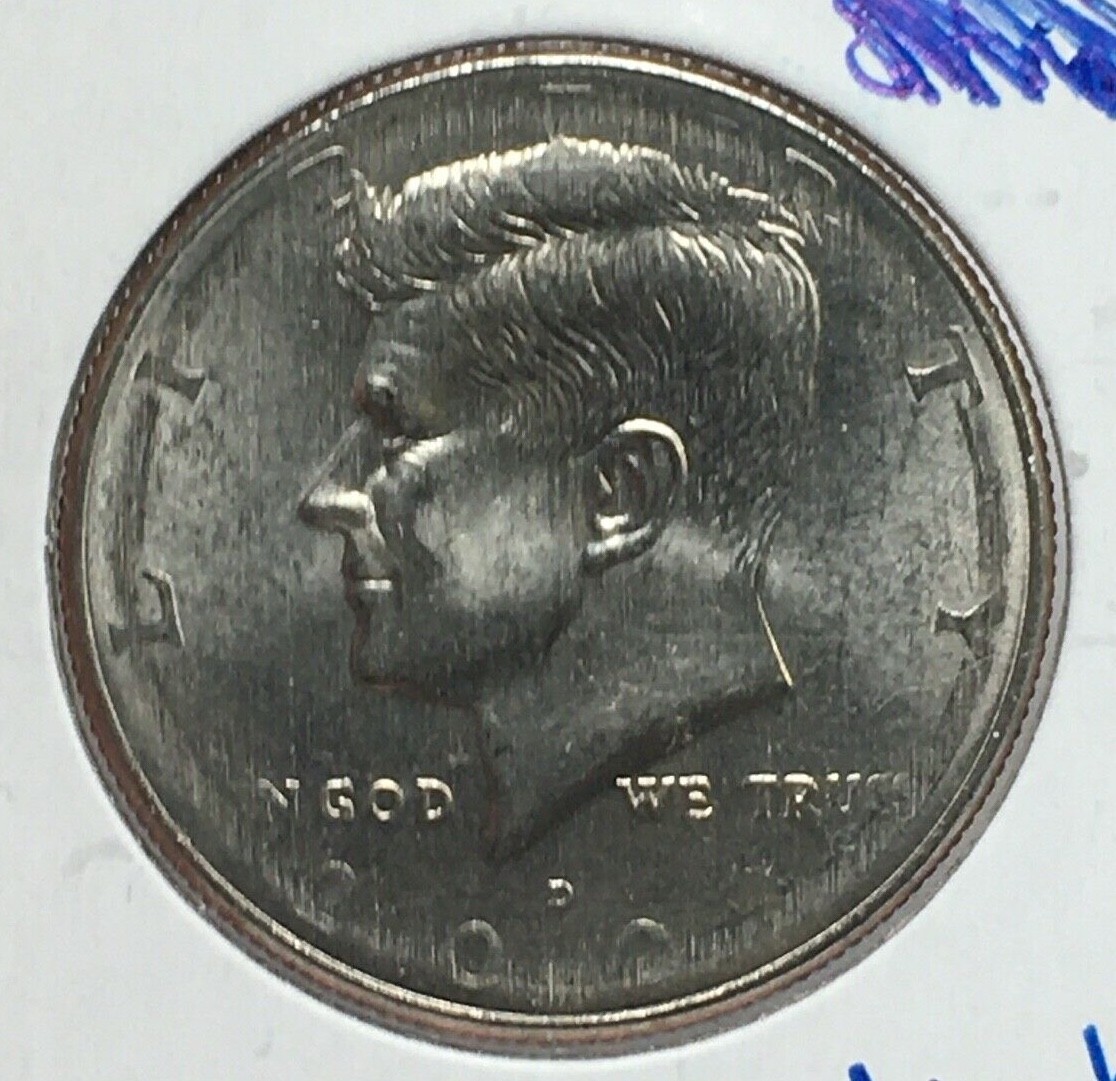 2001 Kennedy half dollar broadstrike error showing expanded diameter and thinner profile compared to a normal specimen
